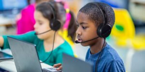 Students using Encore Data Products AVID classroom headsets with microphones during digital learning on laptops