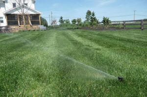 An automatic sprinkler system waters a lush residential lawn, highlighting professional irrigation design and water-efficient landscape care by Aqua-Bright Irrigation LLC