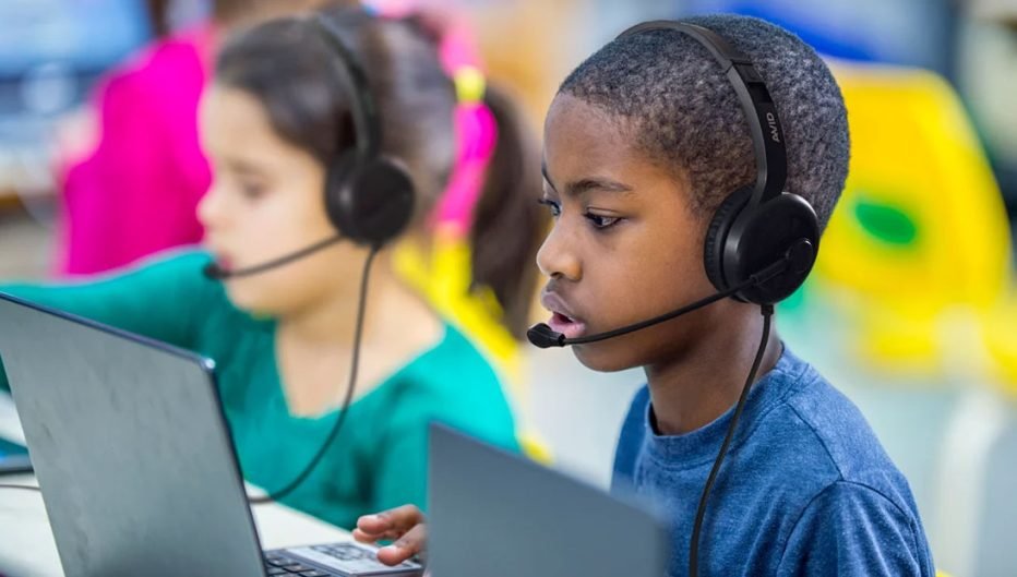 Students using Encore Data Products AVID classroom headsets with microphones during digital learning on laptops