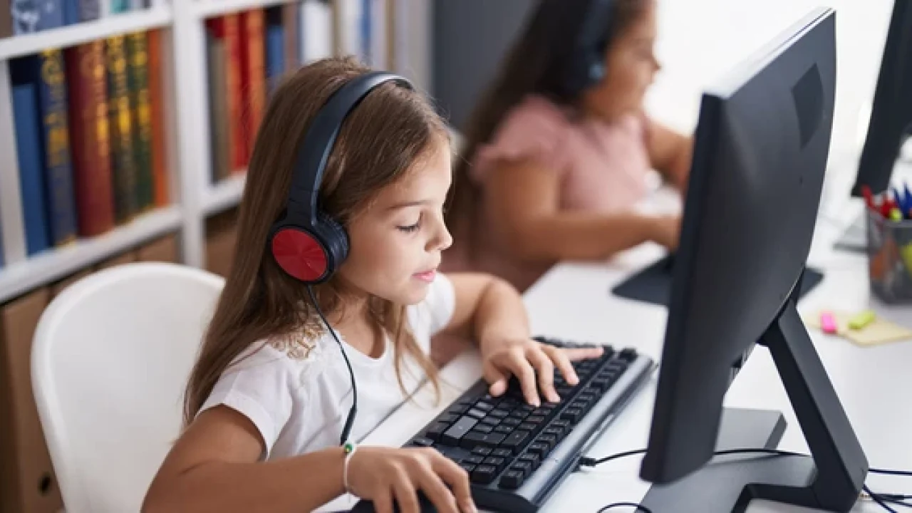 Student using Amira tests headphones from Encore Data Products while using a desktop computer at a workstation
