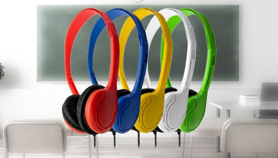 Colorful over-ear classroom headphones in red, blue, yellow, white, and green displayed in front of a classroom chalkboard, representing durable educational audio solutions from Encore Data Products